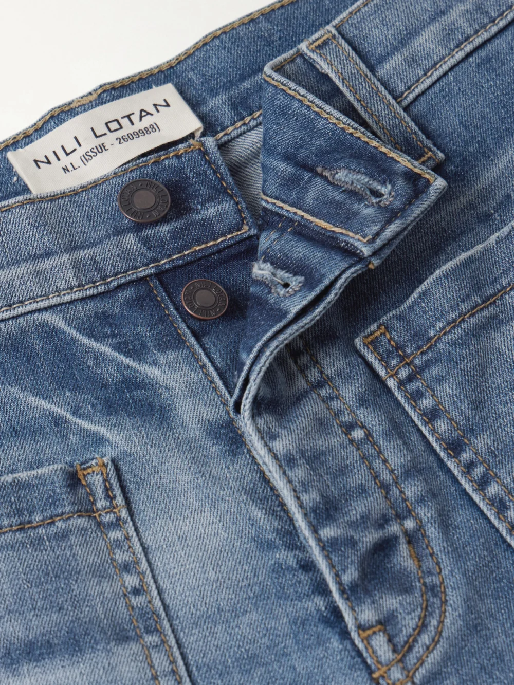 Close-up detail of the Nili Lotan Florence Distressed High-rise Flared Jeans