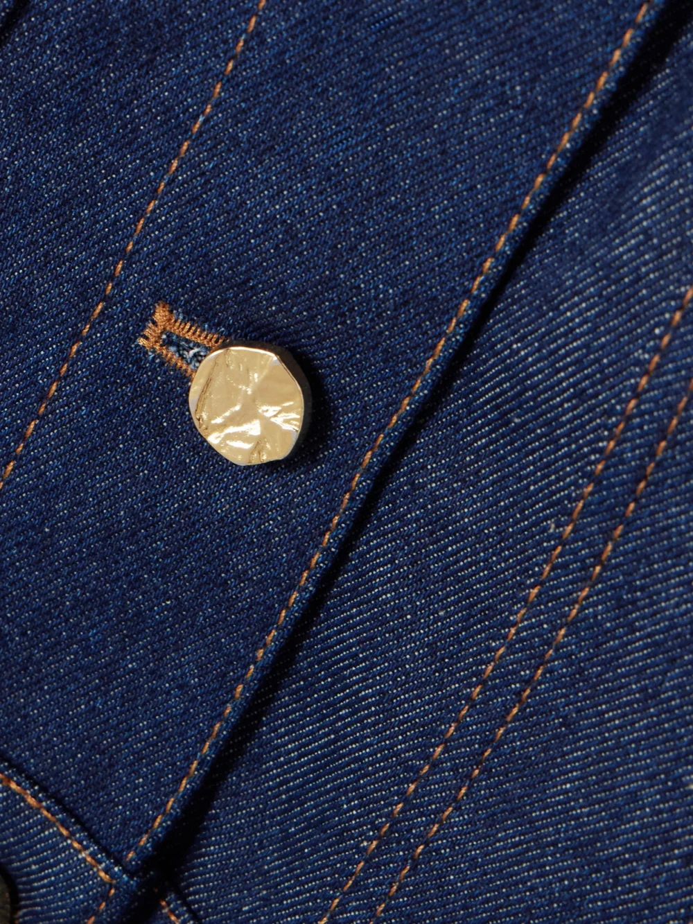 Close-up detail of the Nina Ricci Cropped Topstitched Denim Jacket