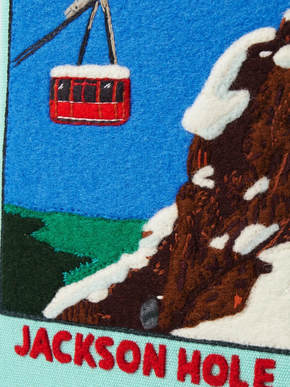 Close-up detail of the Olympia Le-Tan Jackson Hole Embroidered Appliquéd Canvas Clutch