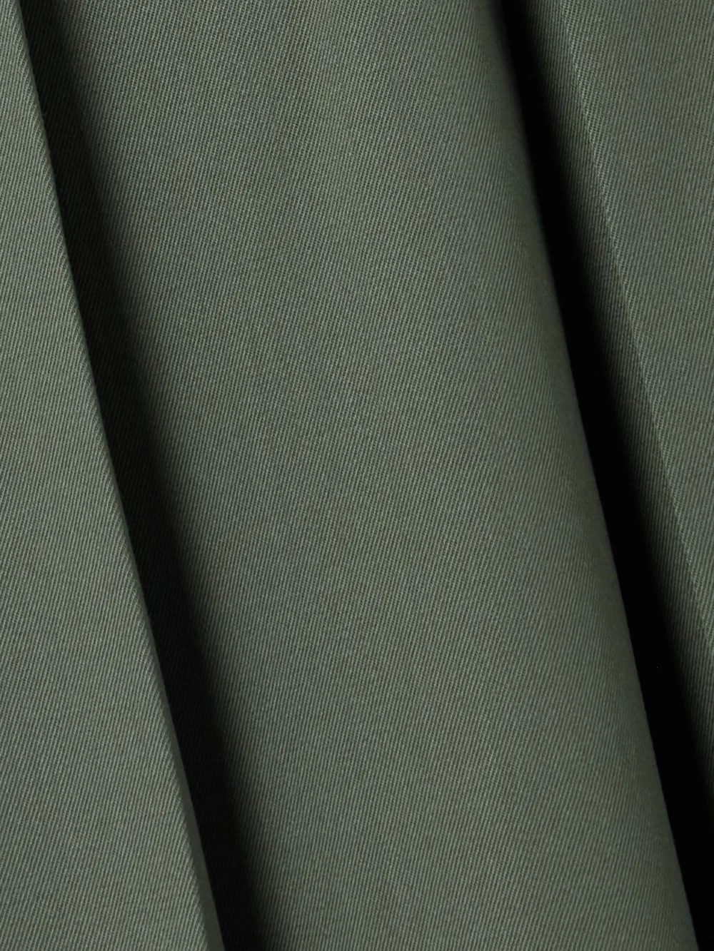 Close-up detail of the Patou Belted Pleated Stretch-wool Twill Midi Skirt