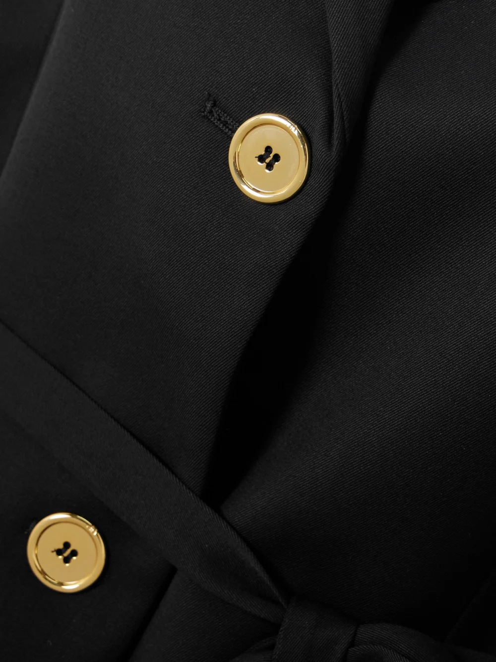 Close-up detail of the Patou Belted Stretch-wool Twill Blazer