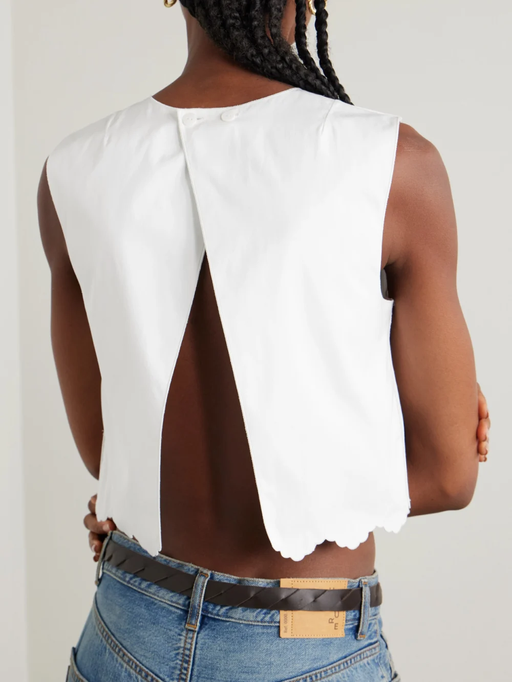Back view of the Patou Cropped Open-back Scalloped Cotton-poplin Top