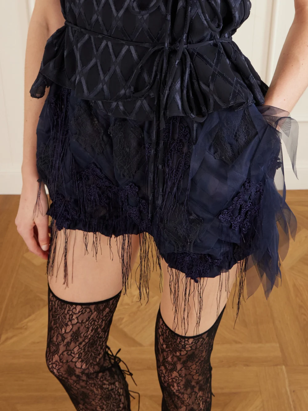 Close-up detail of the Pauline Dujancourt Argyle Fringed Lace and Crochet-trimmed Tulle Shorts