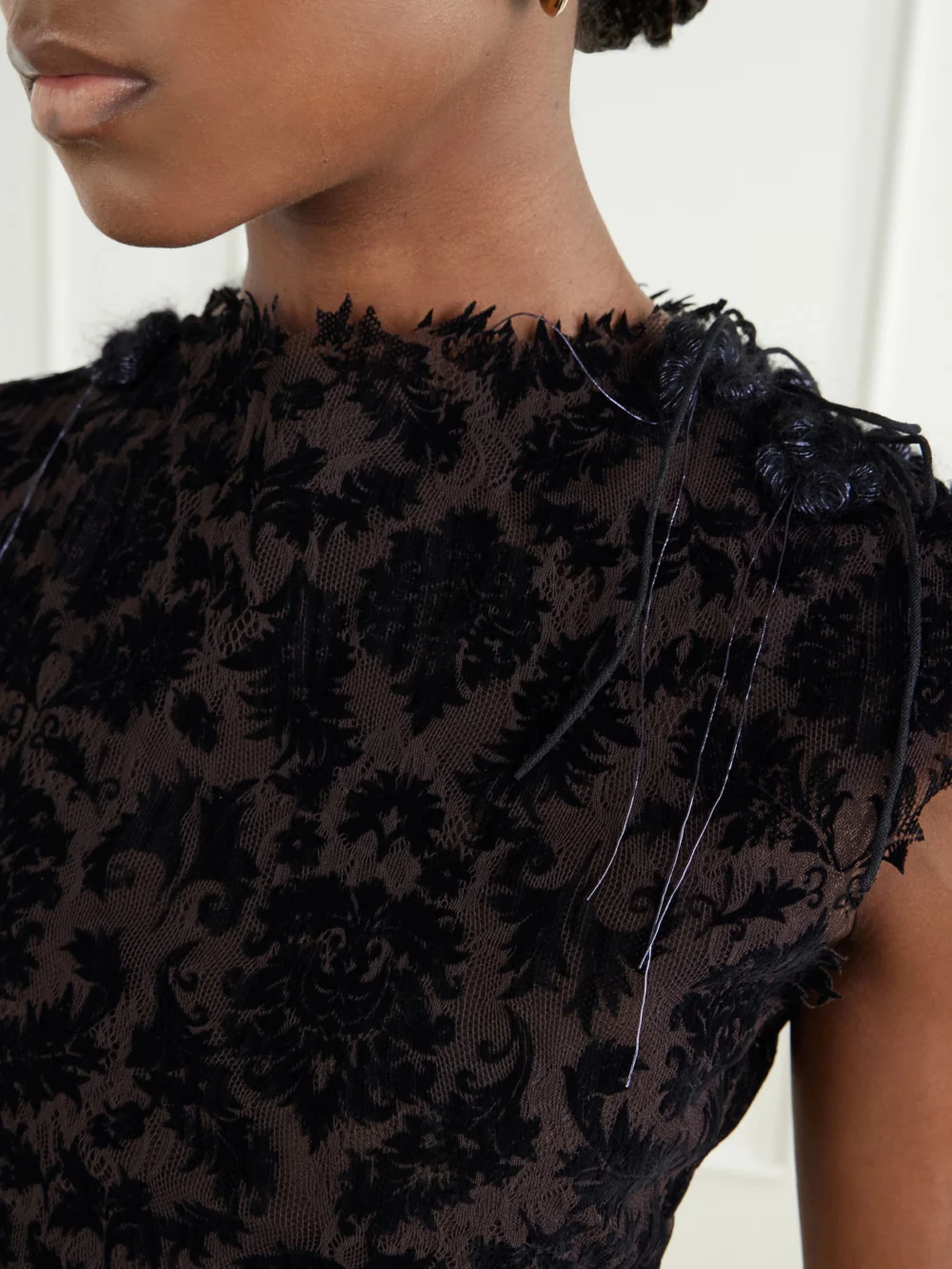 Close-up detail of the Pauline Dujancourt Najia Asymmetric Lace Midi Dress