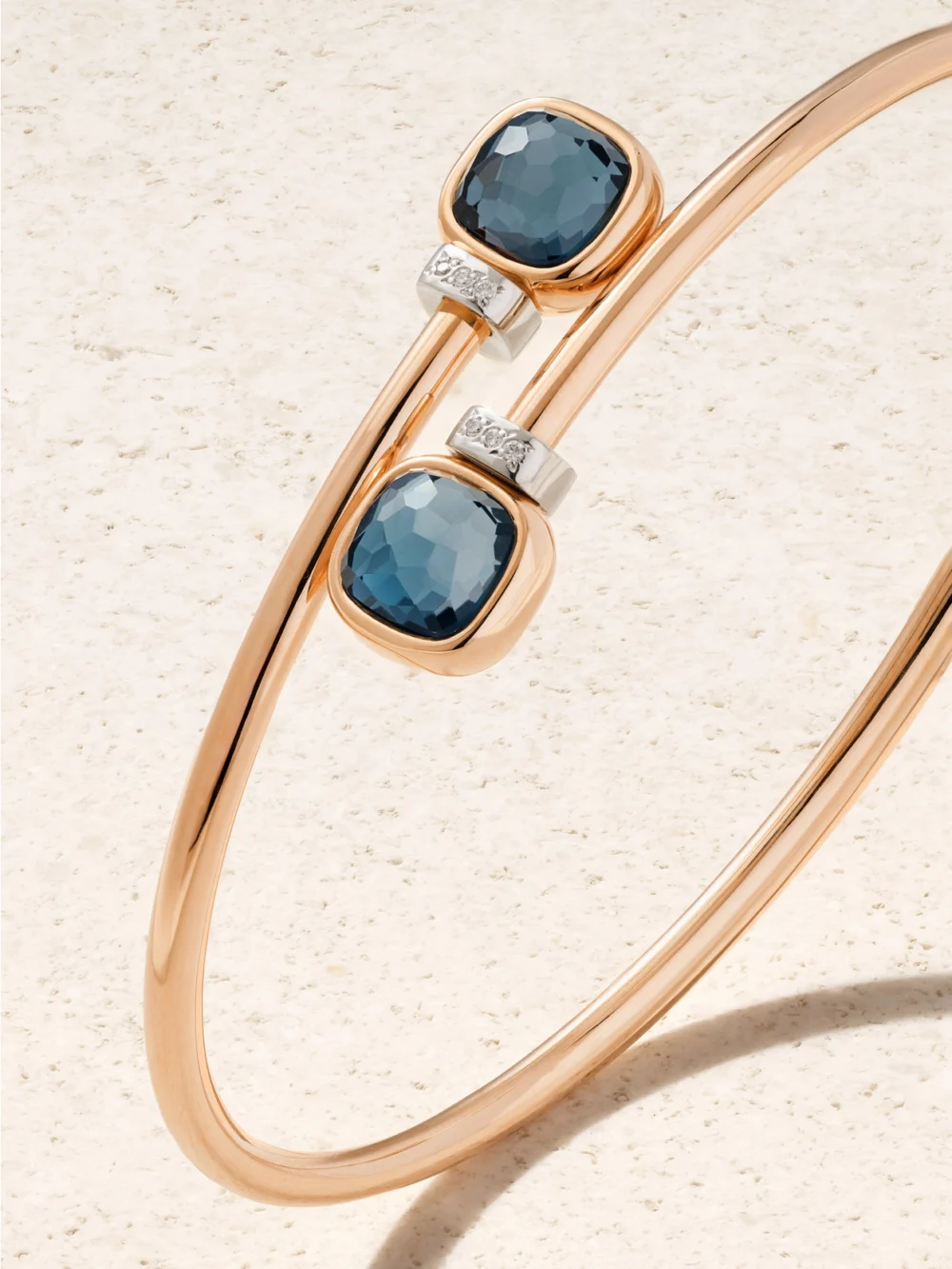 Close-up detail of the Pomellato Mini Nudo 18-karat Rose and White Gold, Topaz and Diamond Bangle