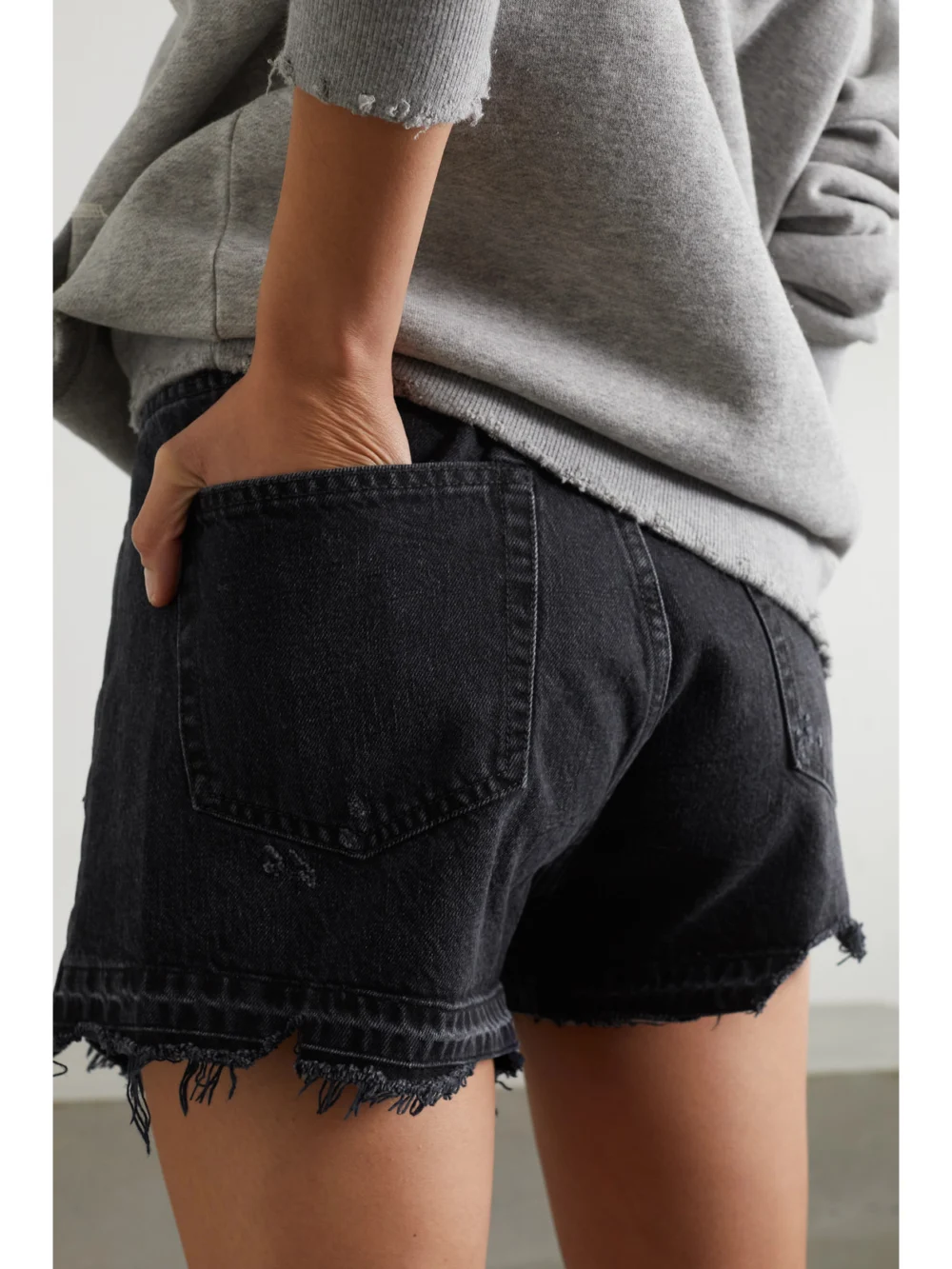 Back view of the R13 Crossover Asymmetric Distressed Denim Shorts