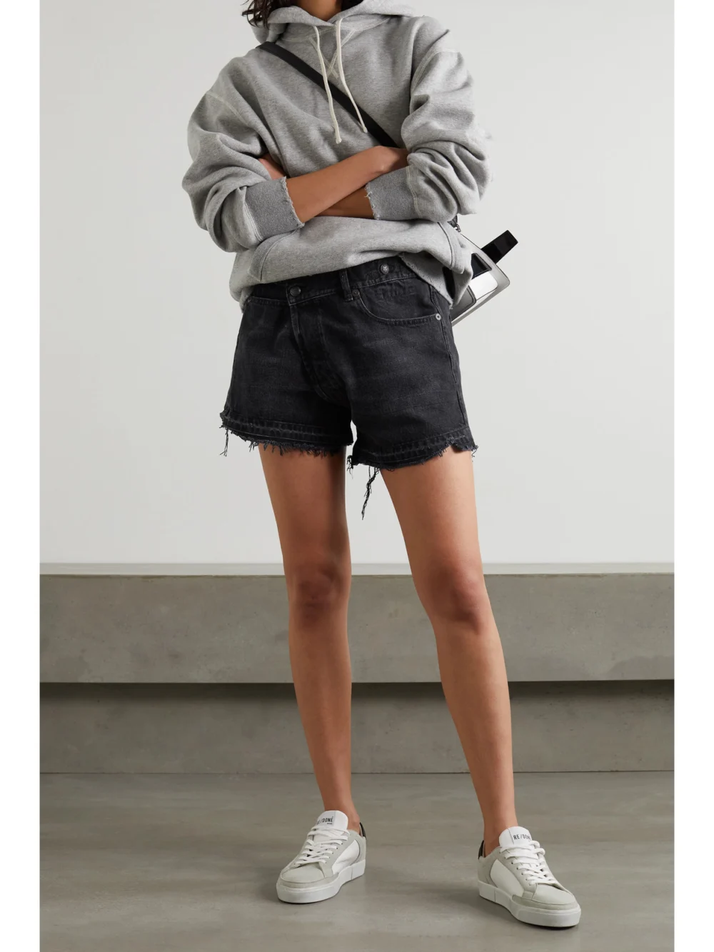 R13 Crossover Asymmetric Distressed Denim Shorts, worn by a model