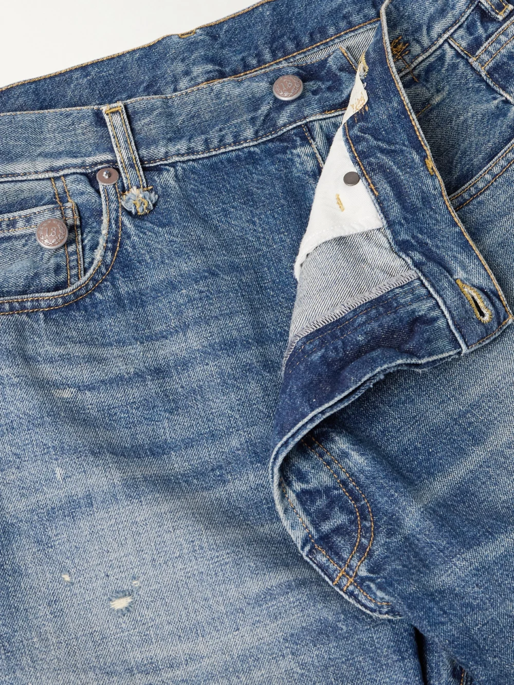 Close-up detail of the R13 Crossover Asymmetric Distressed Low-rise Straight-leg Jeans
