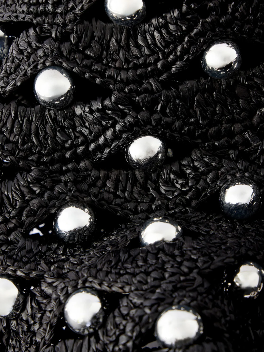 Close-up detail of the Rabanne Embellished Leather-trimmed Raffia Crossbody Bag