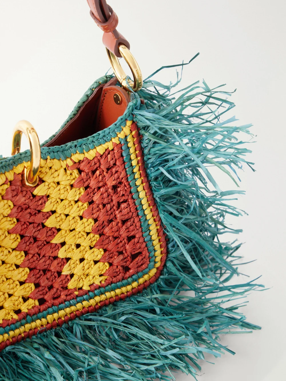 Close-up detail of the Rabanne Leather-trimmed Fringed Raffia Shoulder Bag