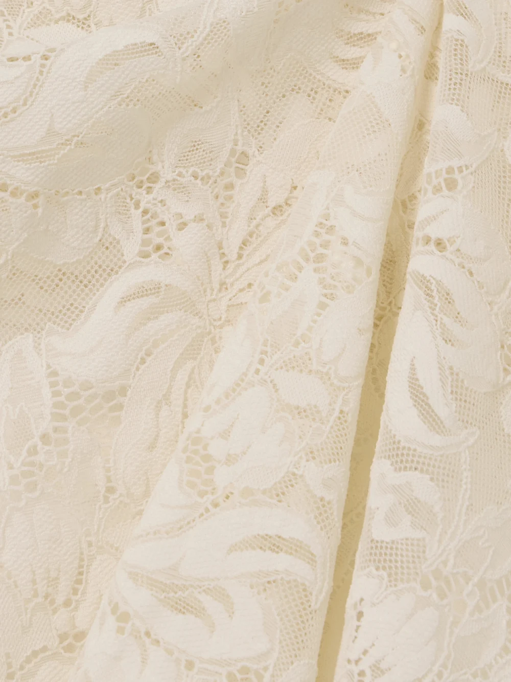 Close-up detail of the Rabanne Scalloped Lace Midi Skirt