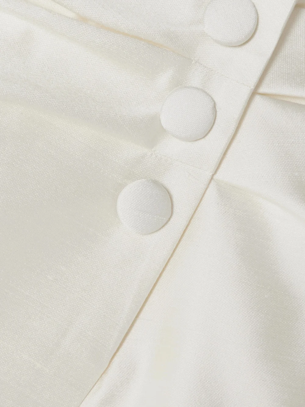 Close-up detail of the Rasario Ruched Button-embellished Silk Mini Skirt