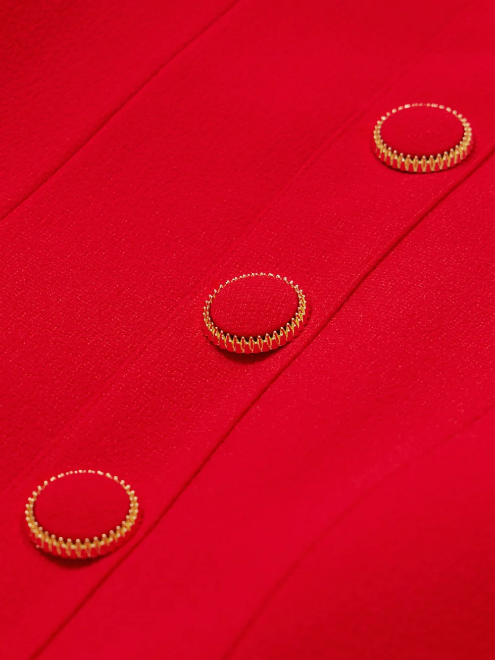 Close-up detail of the Rebecca Vallance Cameron Button-embellished Crepe Mini Dress