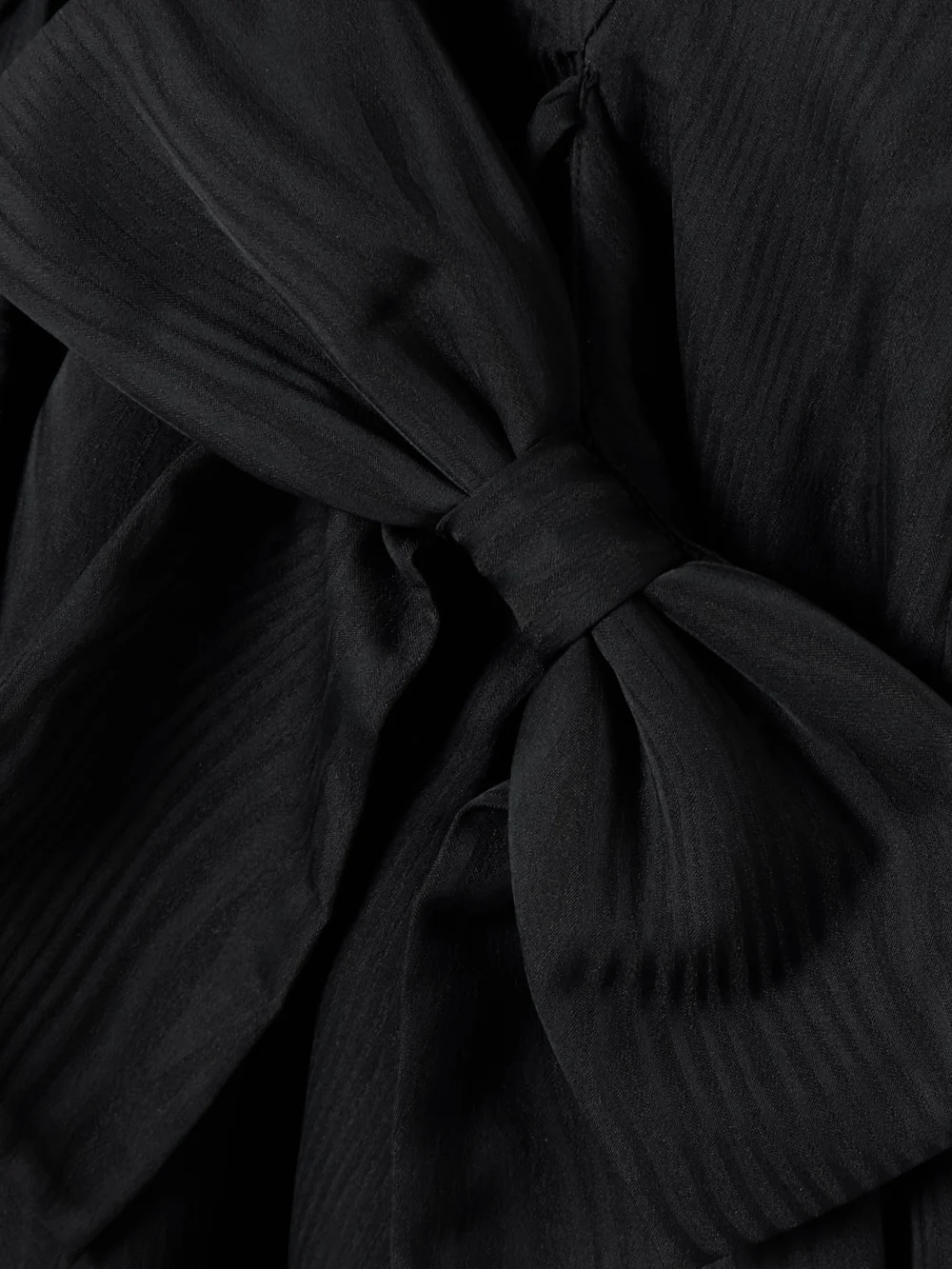 Close-up detail of the Rebecca Vallance Narcissa Bow-embellished Gathered Moire Midi Dress