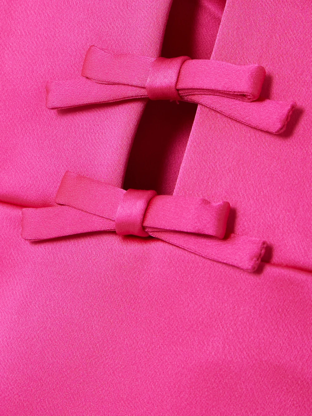 Close-up detail of the Rebecca Vallance Saskia Bow-embellished Cutout Satin Mini Dress