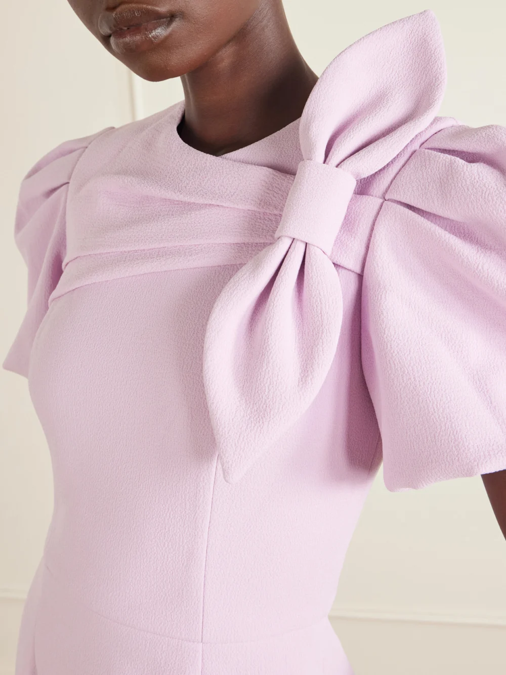 Close-up detail of the Rebecca Vallance Yolanda Bow-detail Crepe Mini Dress