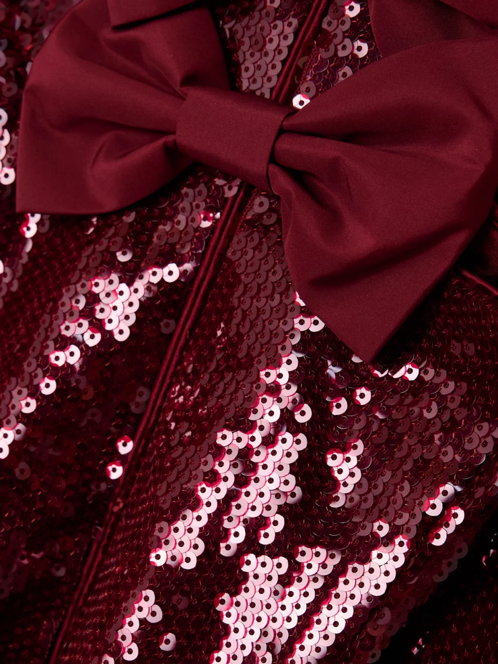 Close-up detail of the Rebecca Vallance Zelda Bow-detailed Sequined Satin Midi Dress