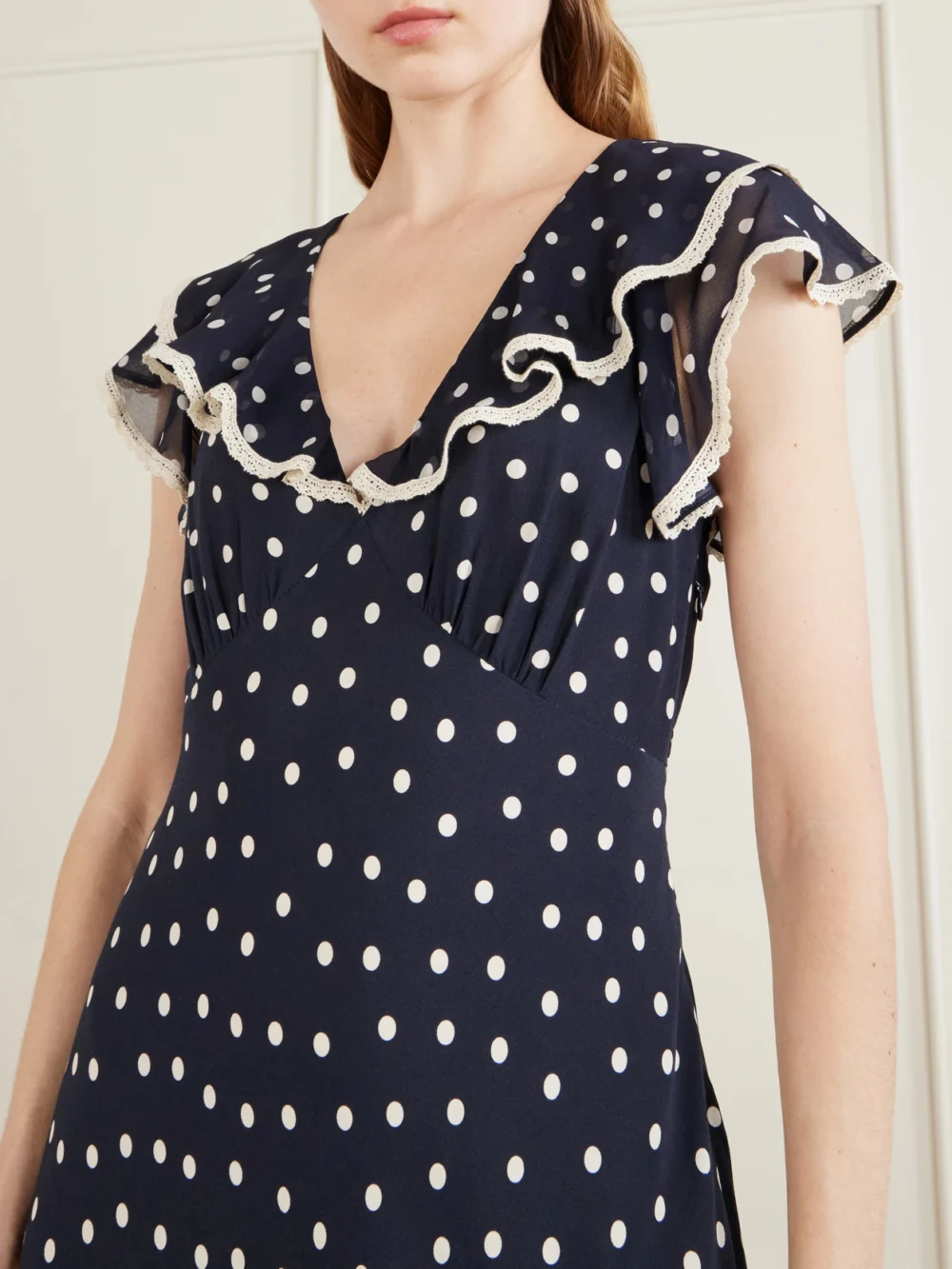 Close-up detail of the Rixo Bethea Crochet-trimmed Polka-dot Crepe Midi Dress