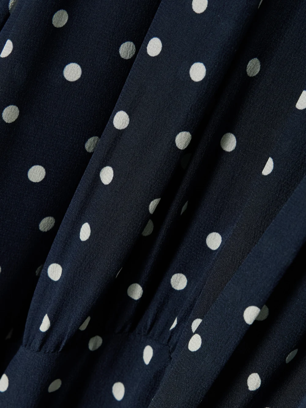 Close-up detail of the Rixo Paige Belted Polka-dot Silk-chiffon Mock-neck Midi Dress