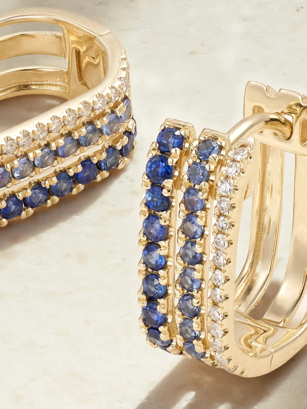 Close-up detail of the Roxanne First Triple 14-karat Gold, Sapphire and Diamond Hoop Earrings