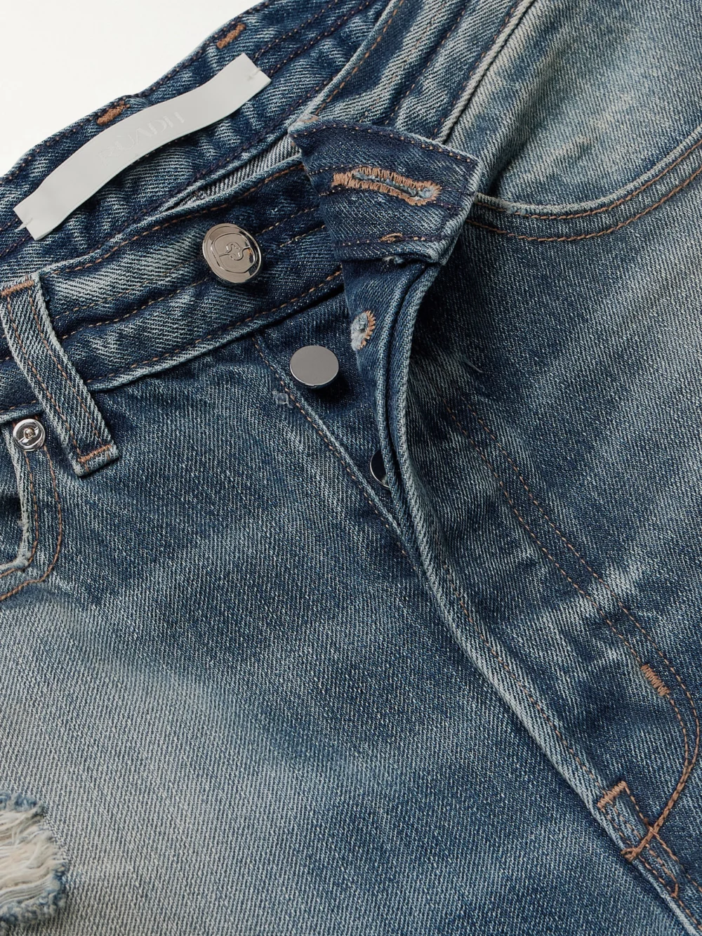 Close-up detail of the Rùadh The Agnes Distressed Mid-rise Straight-leg Jeans