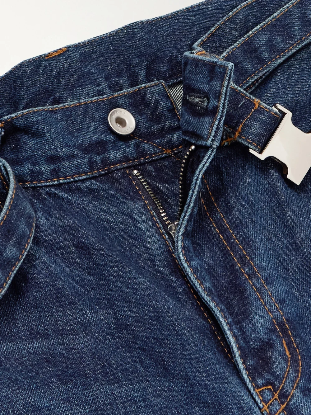 Close-up detail of the Sacai Belted Bootcut Jeans