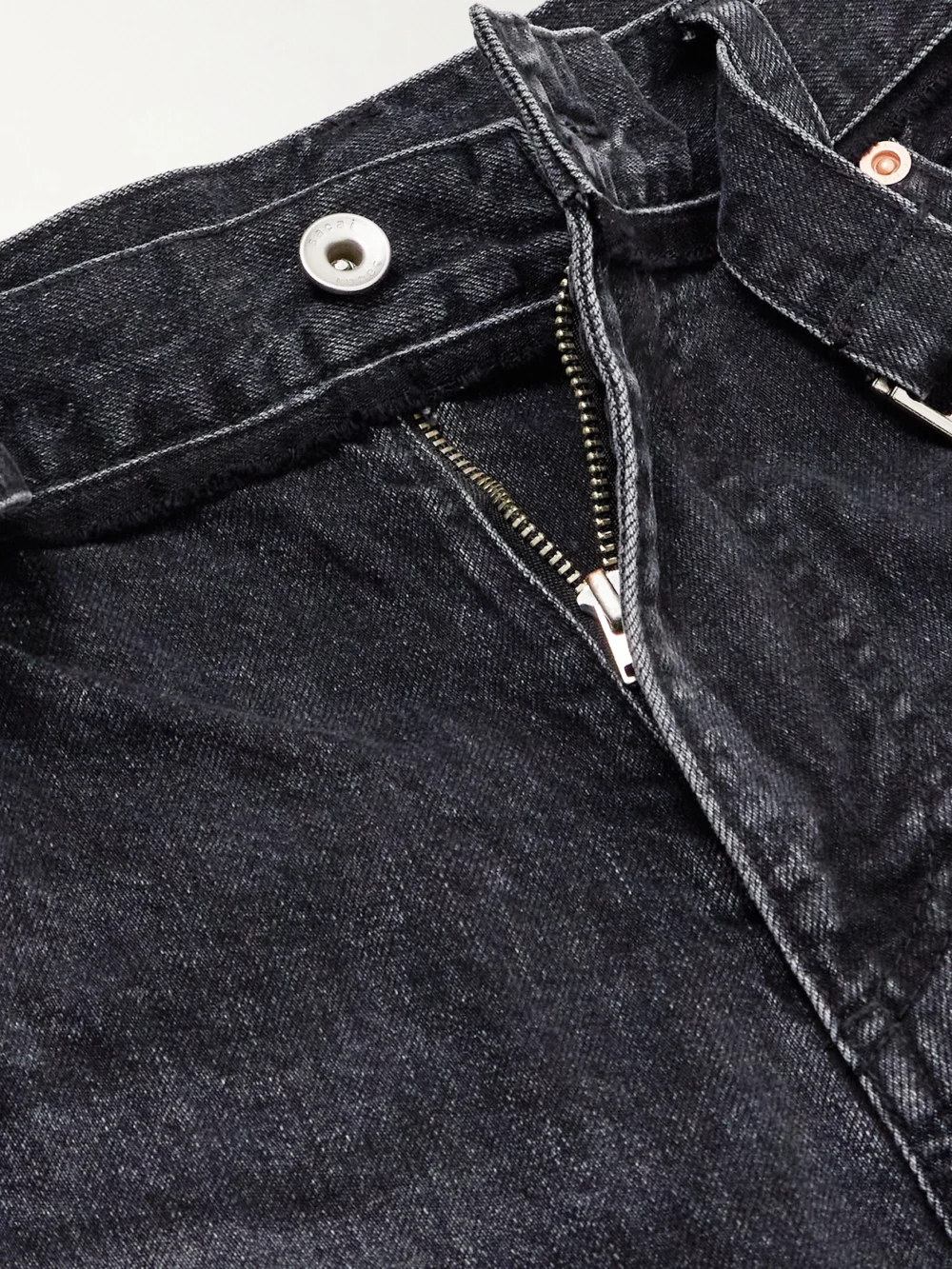 Close-up detail of the Sacai Belted High-rise Wide-leg Jeans