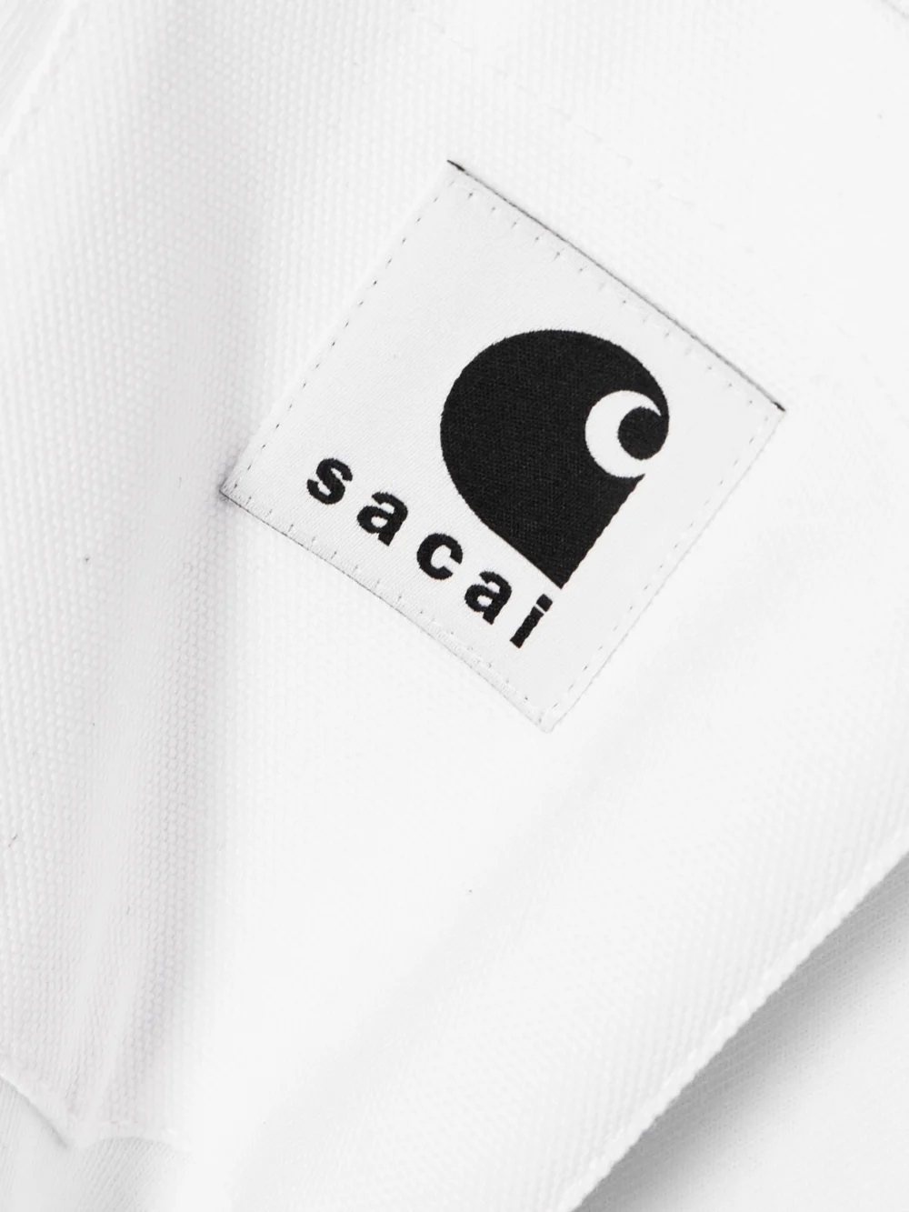 Close-up detail of the Sacai + Carhartt Wip Appliquéd Canvas-trimmed Cotton-jersey T-shirt