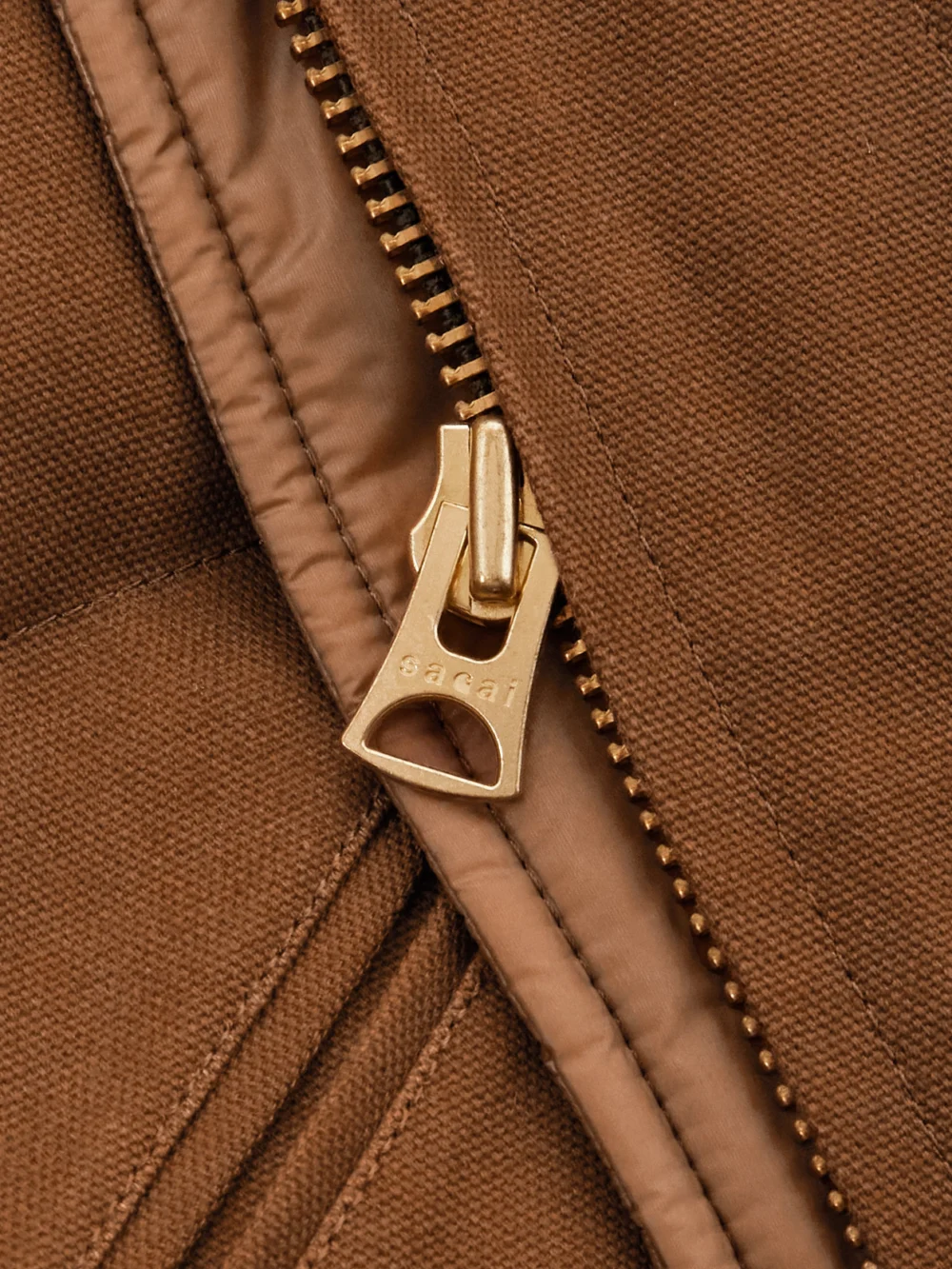 Close-up detail of the Sacai + Carhartt Wip Cropped Corduroy-trimmed Quilted Shell and Cotton-canvas Down Jacket