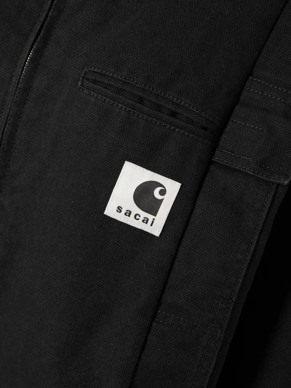 Close-up detail of the Sacai + Carhartt Wip Duck Oversized Corduroy-trimmed Appliquéd Cotton-canvas Jacket