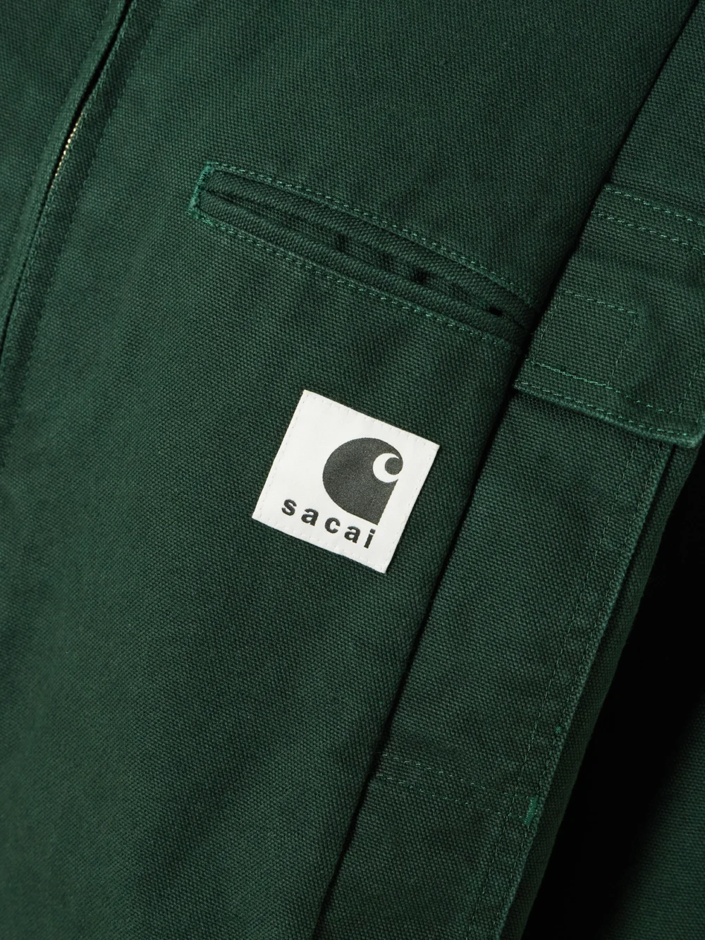 Close-up detail of the Sacai + Carhartt Wip Duck Oversized Corduroy-trimmed Appliquéd Cotton-canvas Jacket