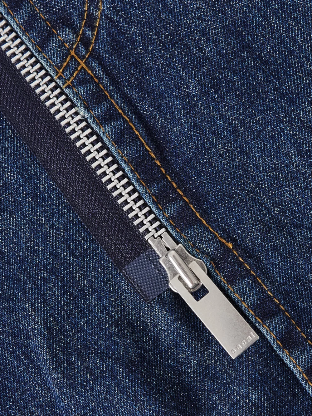 Close-up detail of the Sacai Denim Midi Skirt