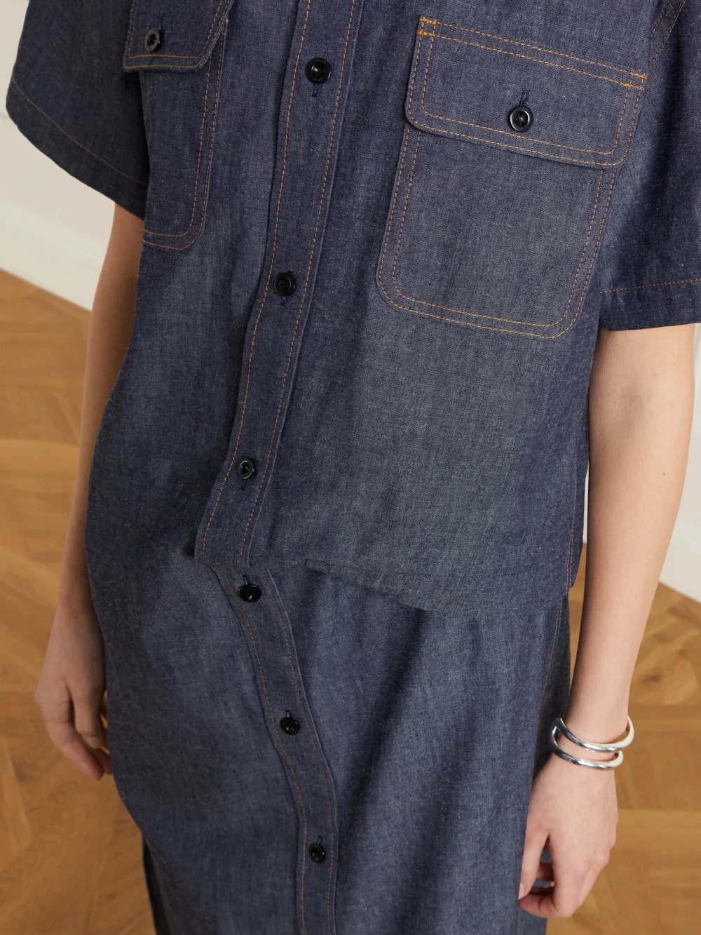 Close-up detail of the Sacai Gathered Denim Midi Dress