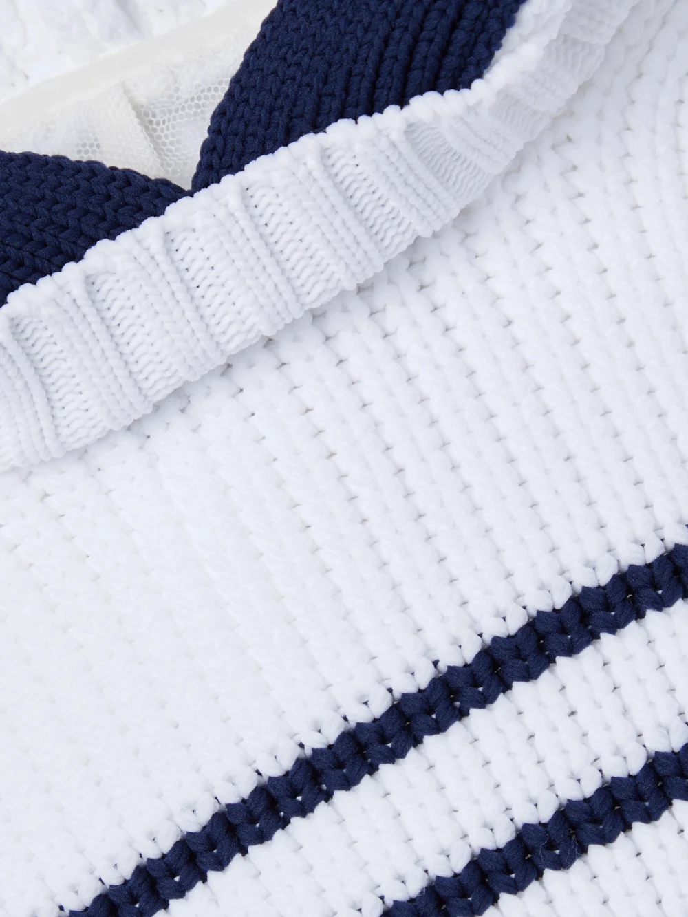 Close-up detail of the Sacai Hooded Striped Ribbed-knit Cape