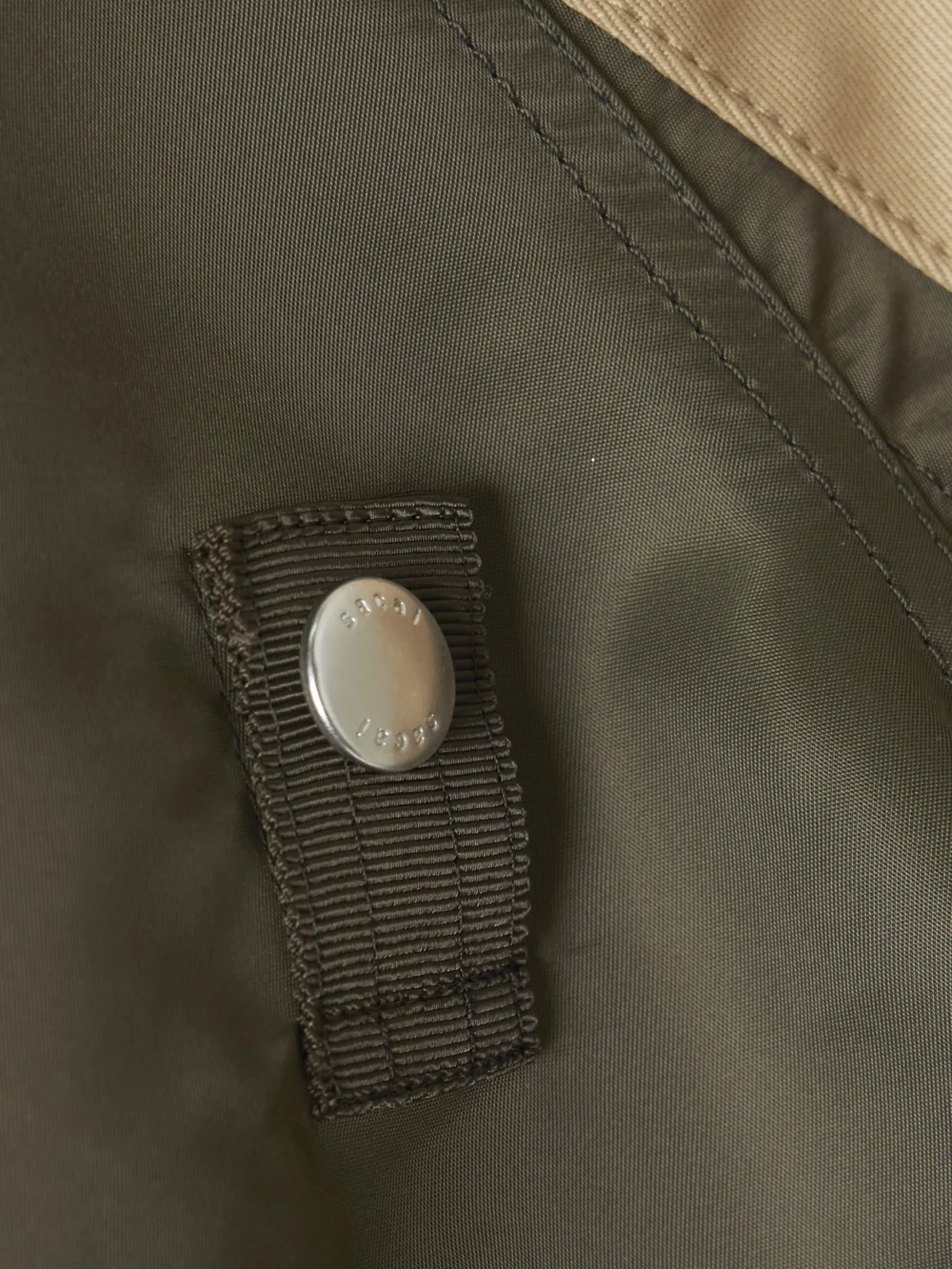 Close-up detail of the Sacai Oversized Cotton-canvas and Shell Bomber Jacket