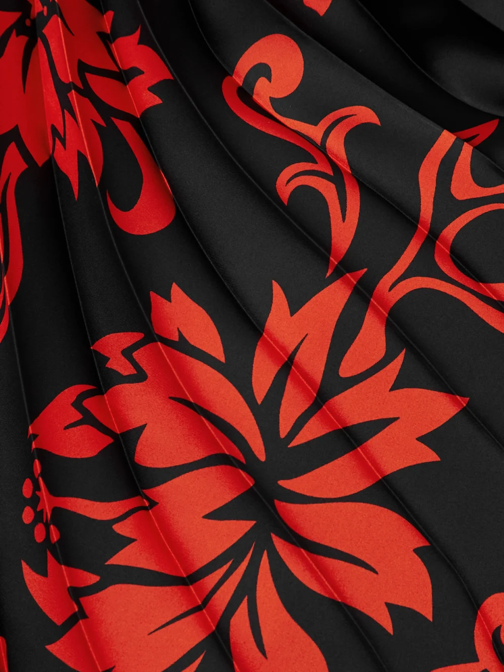 Close-up detail of the Sacai Pleated Floral-print Satin Midi Skirt