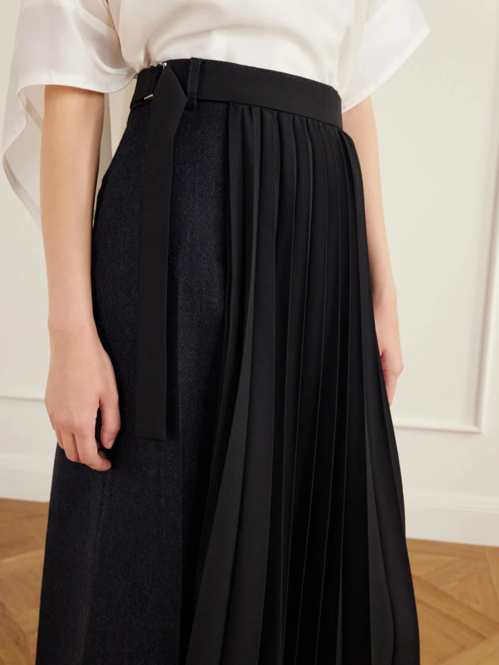Close-up detail of the Sacai Pleated Herringbone Wool-blend Midi Skirt