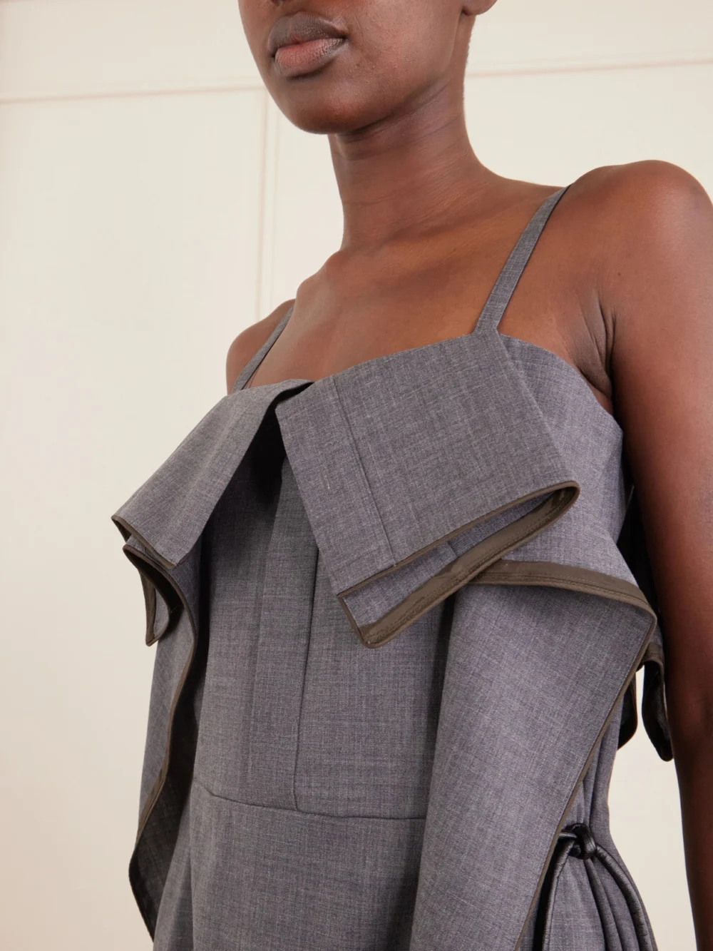 Close-up detail of the Sacai Pleated Ruffled Wool Midi Dress