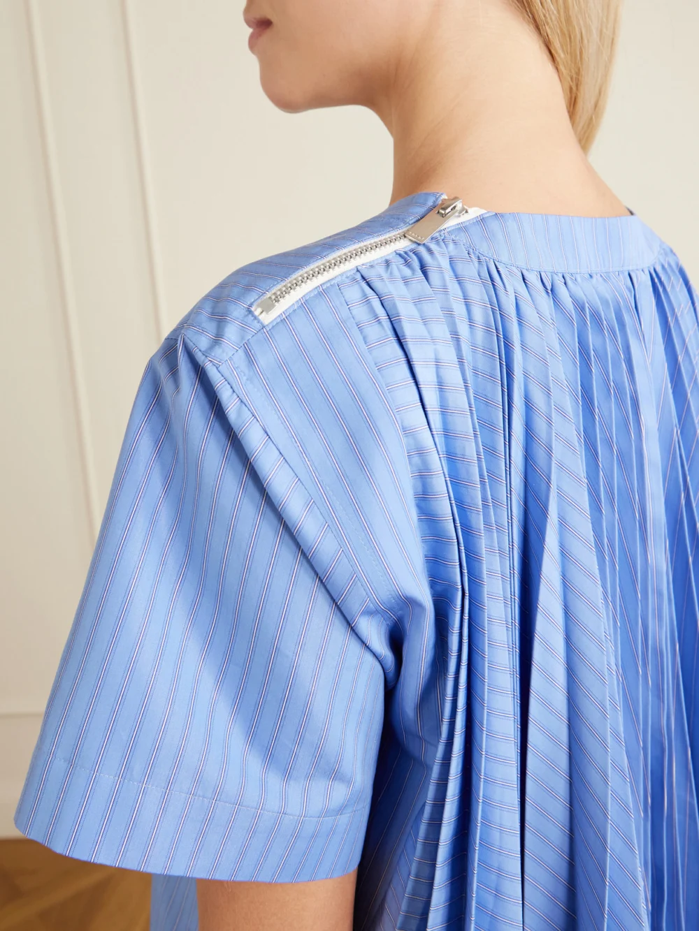 Close-up detail of the Sacai Pleated Striped Cotton-blend Poplin Mini Dress