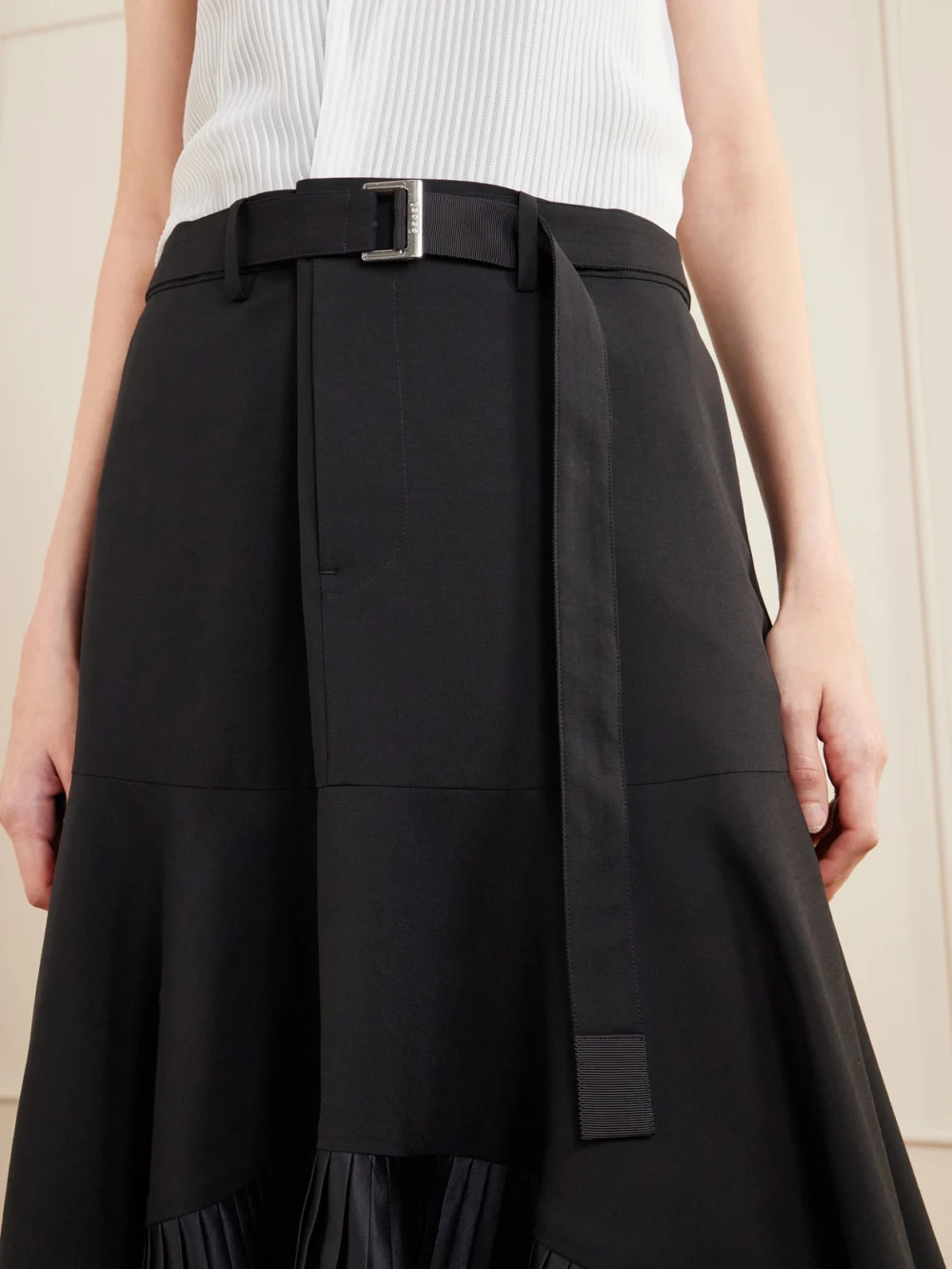 Close-up detail of the Sacai Pleated Wool-trimmed Plissé-chiffon Midi Dress