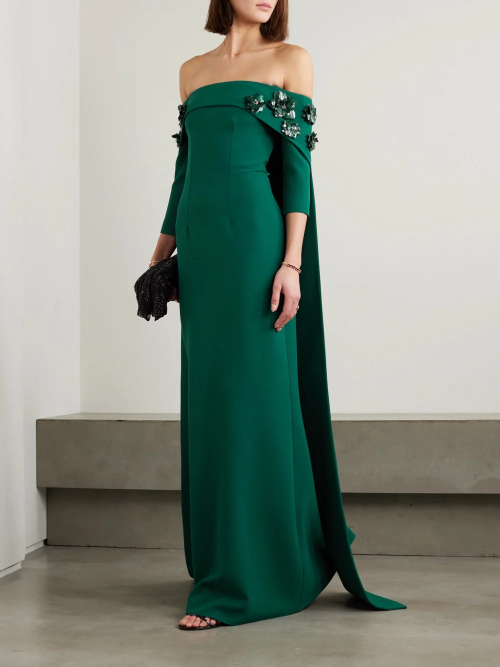 Safiyaa Bellara Off-the-shoulder Cape-effect Embellished Stretch-crepe Gown, worn by a model