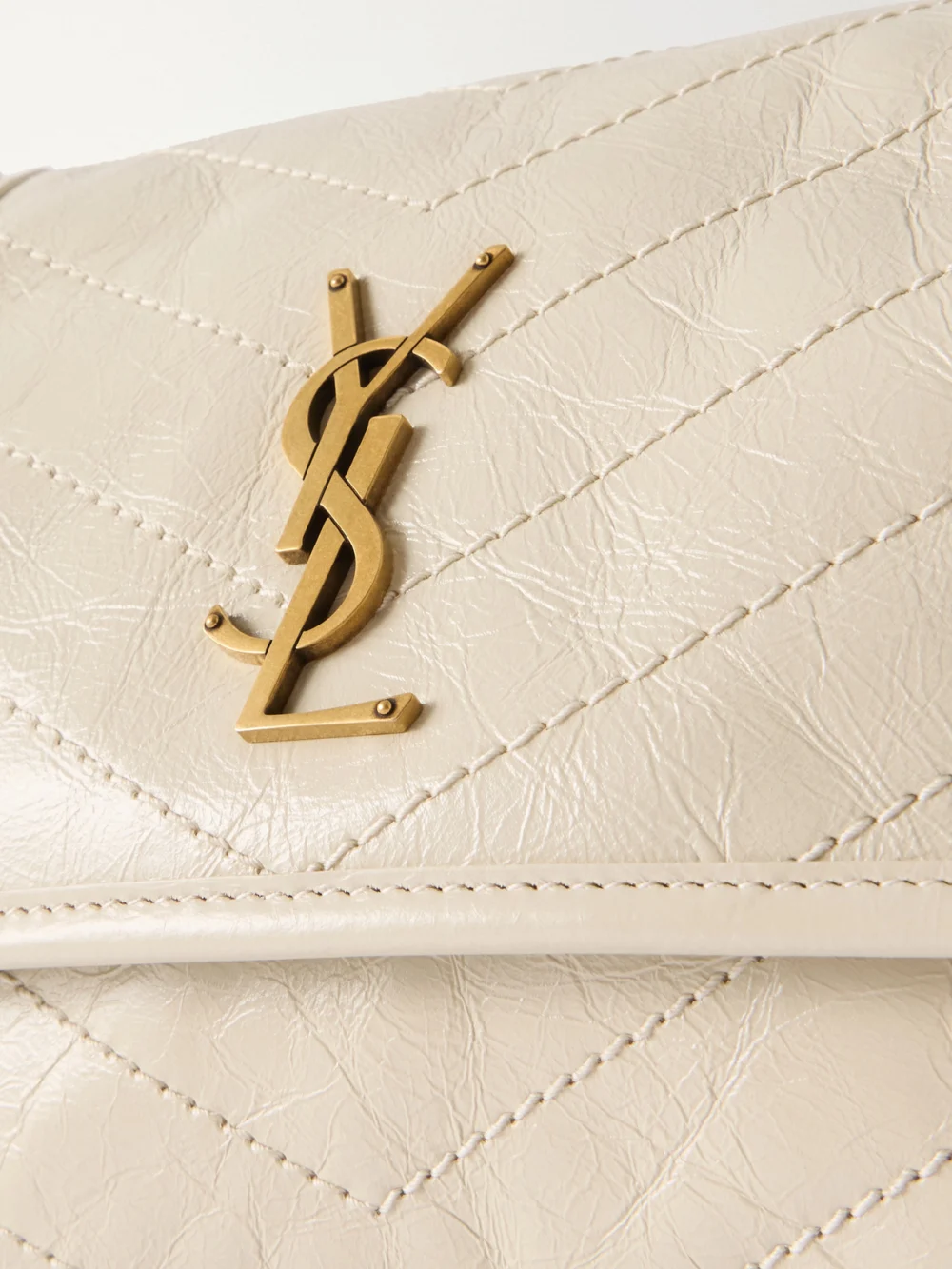 Close-up detail of the Saint Laurent Baby Niki Cassandre-embellished Quilted Crinckled-leather Shoulder Bag