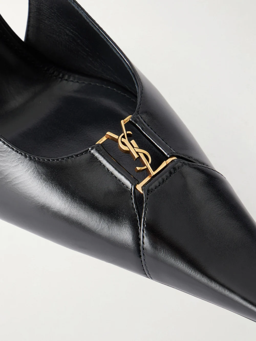 Close-up detail of the Saint Laurent Babylone Cassandre-embellished Cutout Leather Slingback Pumps