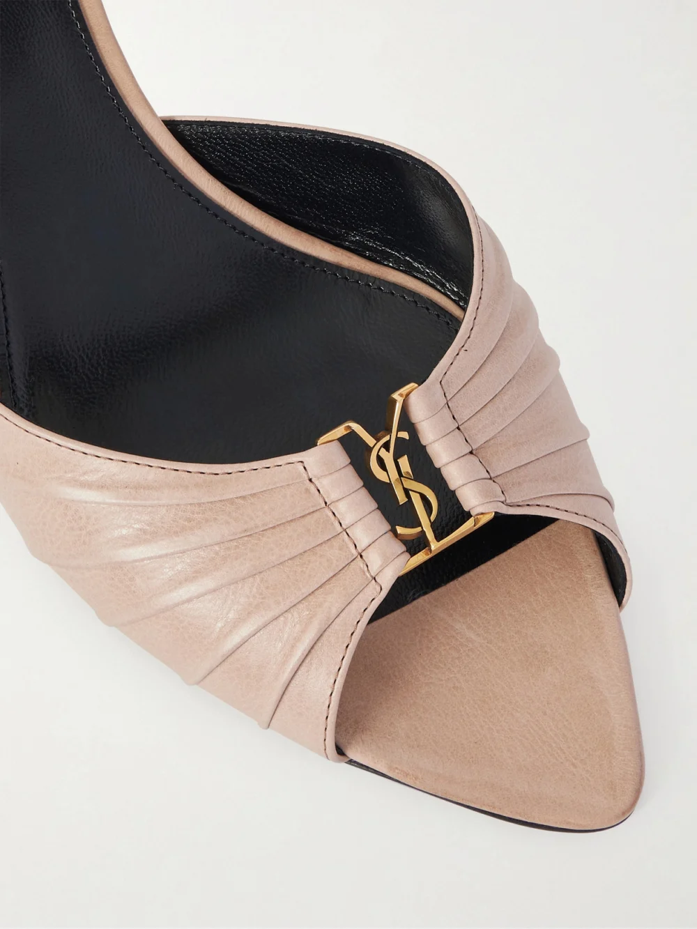 Close-up detail of the Saint Laurent Babylone Cassandre-embellished Gathered Leather Mules