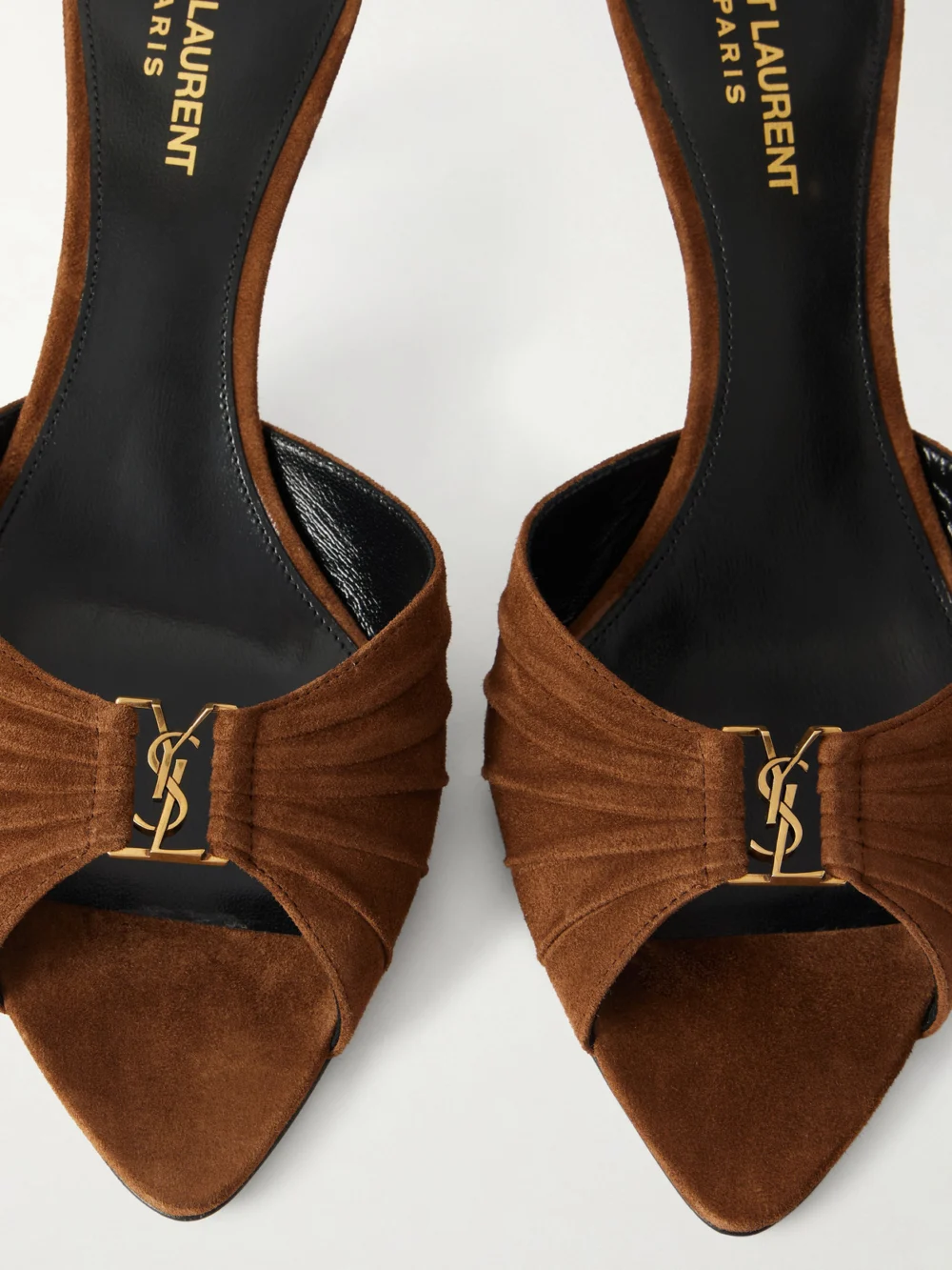 Close-up detail of the Saint Laurent Babylone Cassandre-embellished Gathered Suede Mules
