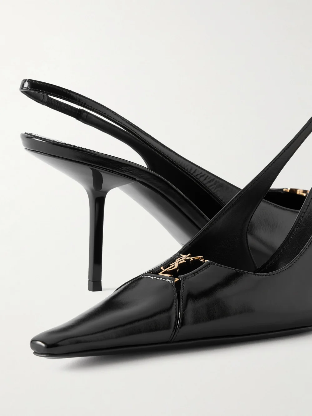 Close-up detail of the Saint Laurent Babylone Cassandre-embellished Glossed-leather Slingback Pumps