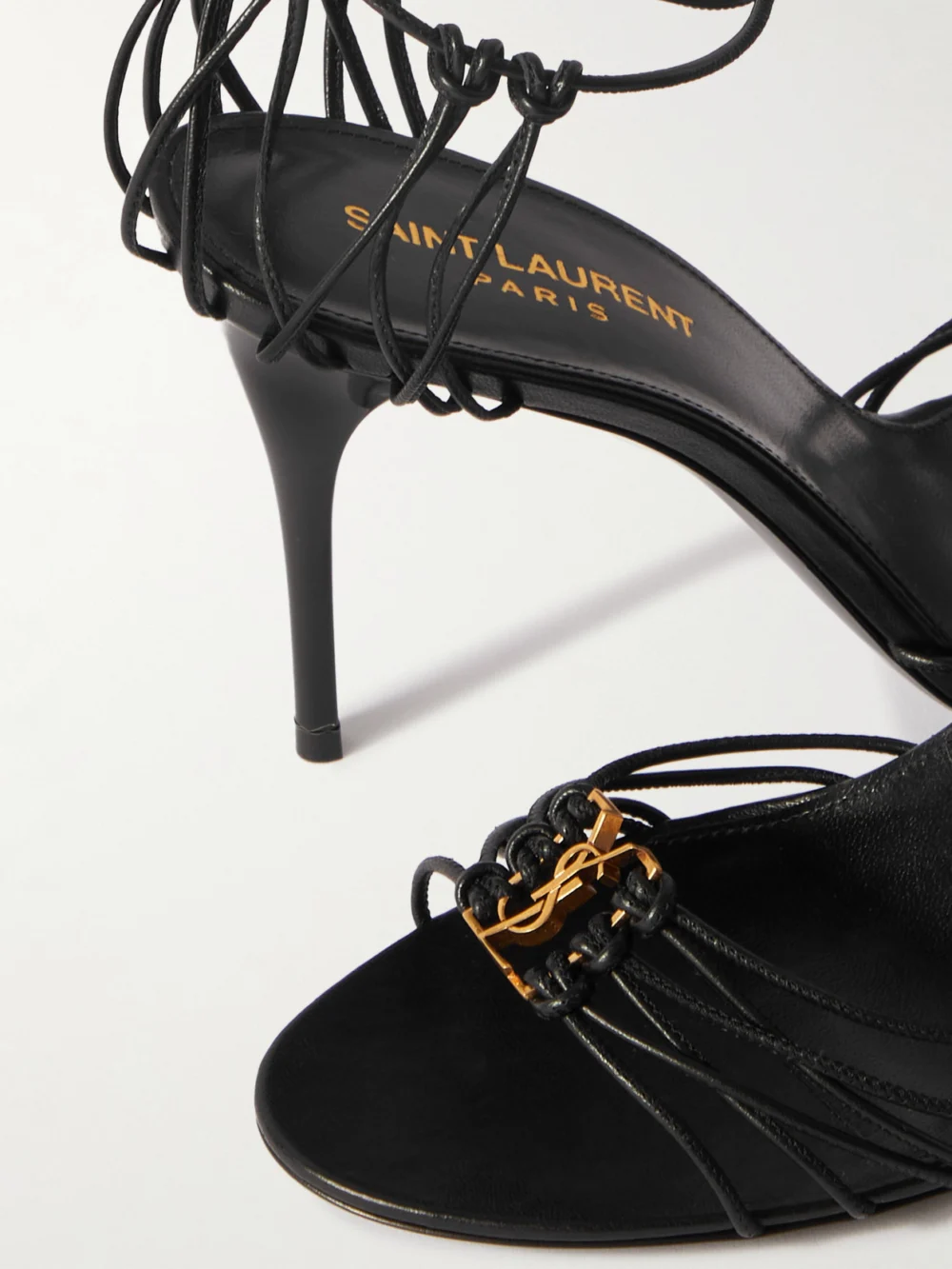 Close-up detail of the Saint Laurent Babylone Cassandre-embellished Knotted Leather Sandals