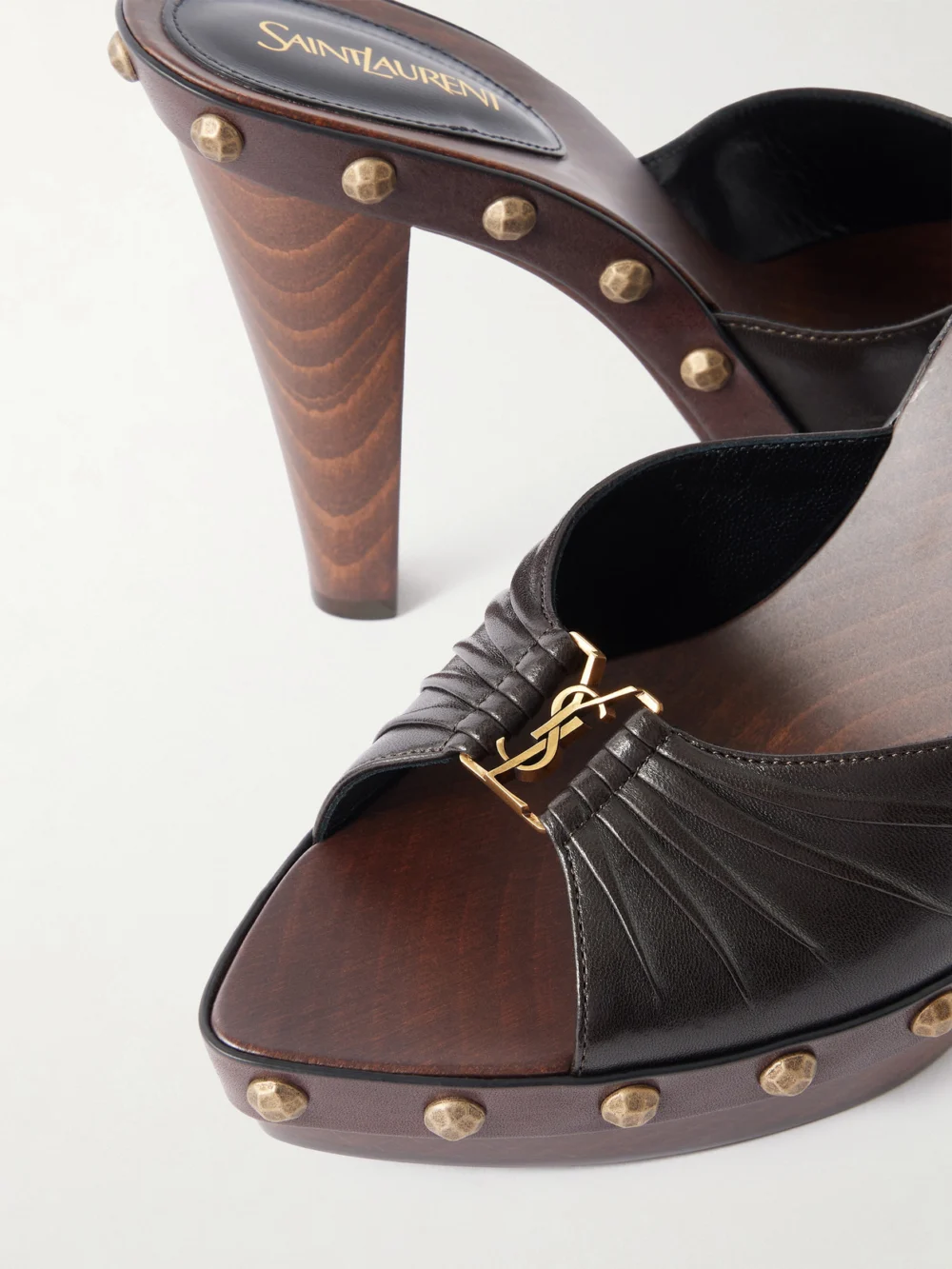 Close-up detail of the Saint Laurent Babylone Cassandre-embellished Leather Mules