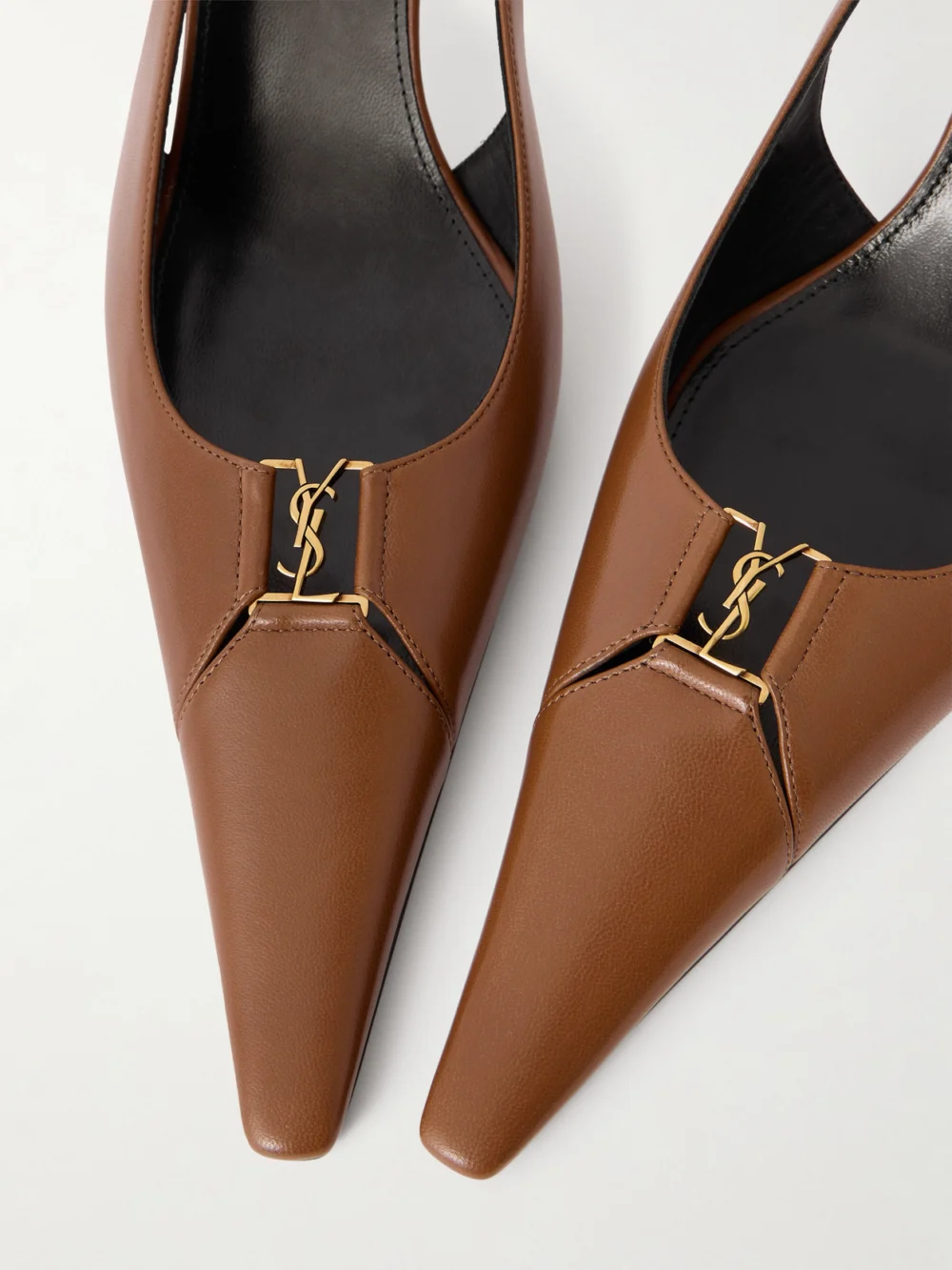 Close-up detail of the Saint Laurent Babylone Cassandre-embellished Leather Slingback Pumps