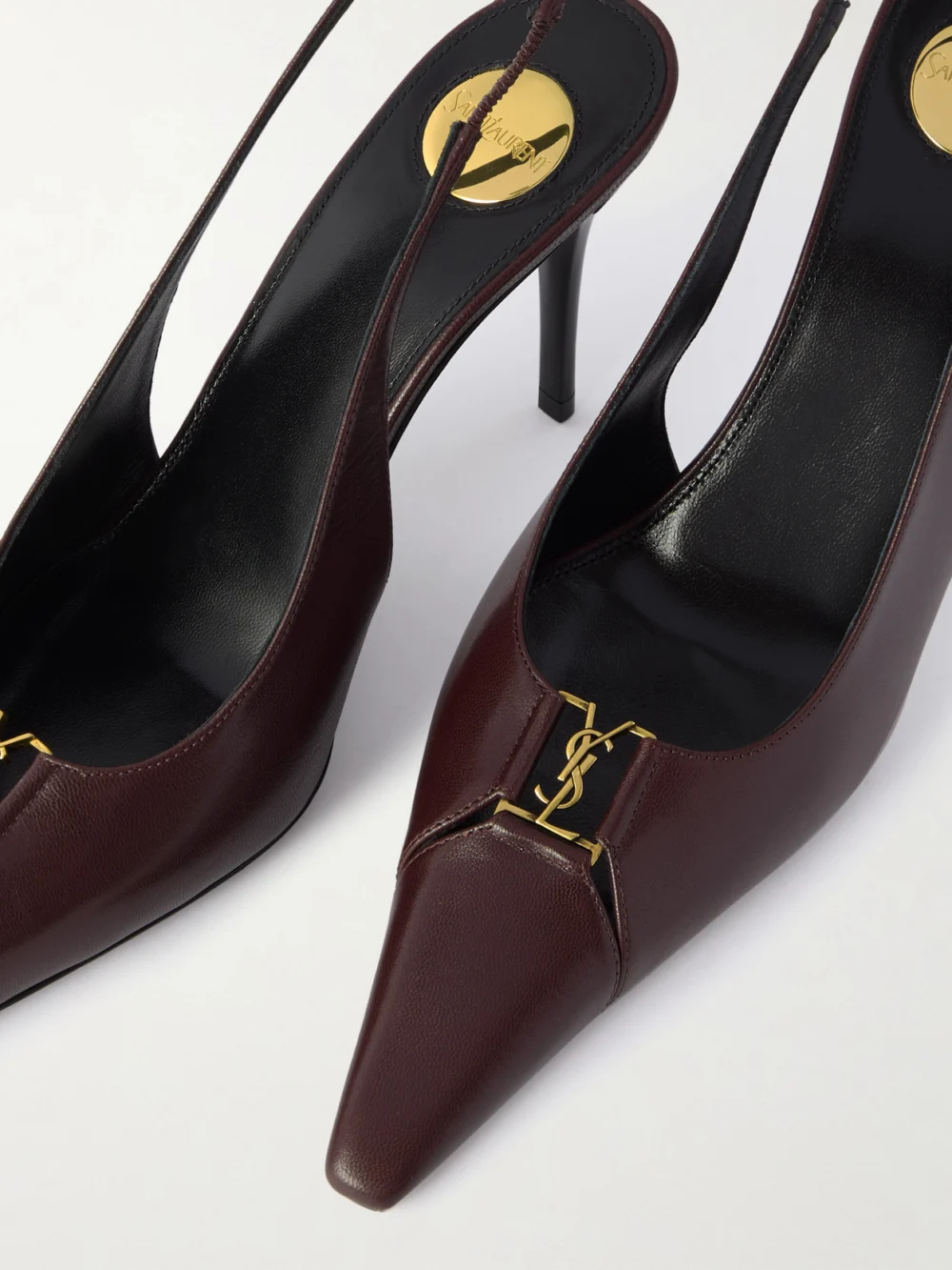 Close-up detail of the Saint Laurent Babylone Cassandre-embellished Leather Slingback Pumps